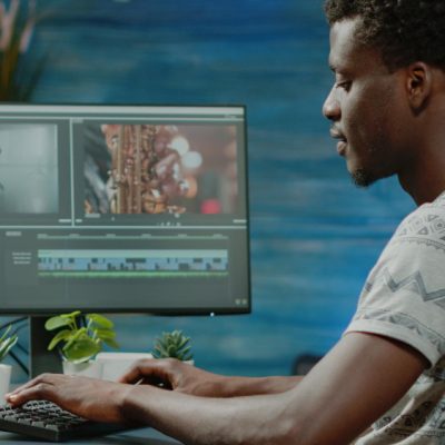 man-working-as-videographer-editing-video-with-musical-footage-freelance-project-film-maker-doing-retouch-work-with-visual-effects-computer-montage-production-content-creator
